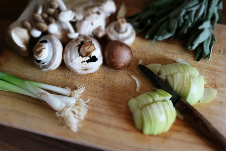 a wooden cutting board topped with mushrooms and onions, by Jessie Algie, unsplash, renaissance, kimitake yoshioka, snails, comforting and familiar, vegetables