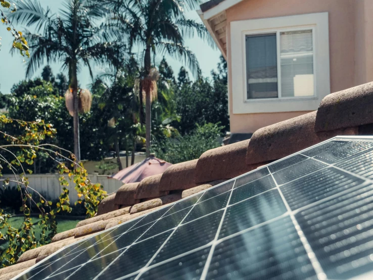 a house with a solar panel on the roof, by Xul Solar, background image, fan favorite, southern california, cinematic view from lower angle