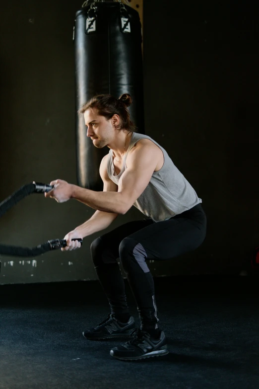 a man squatting in front of a punching bag, pexels contest winner, renaissance, ripped clothes holding whip, profile image, caucasian, quicksilver