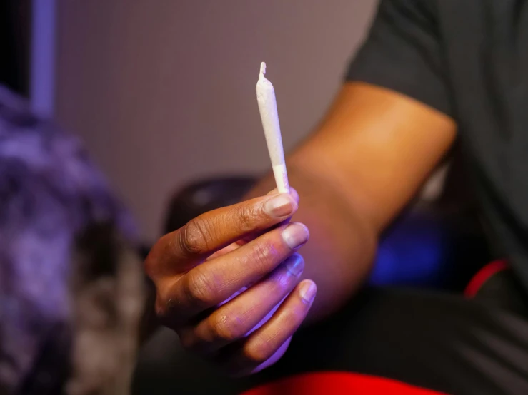 a person holding a lit candle in their hand, smoking a blunt, slide show, multiple stories, white wax