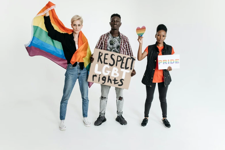 a group of people standing next to each other holding signs, trending on pexels, gay rights, background image, diverse costumes, three women