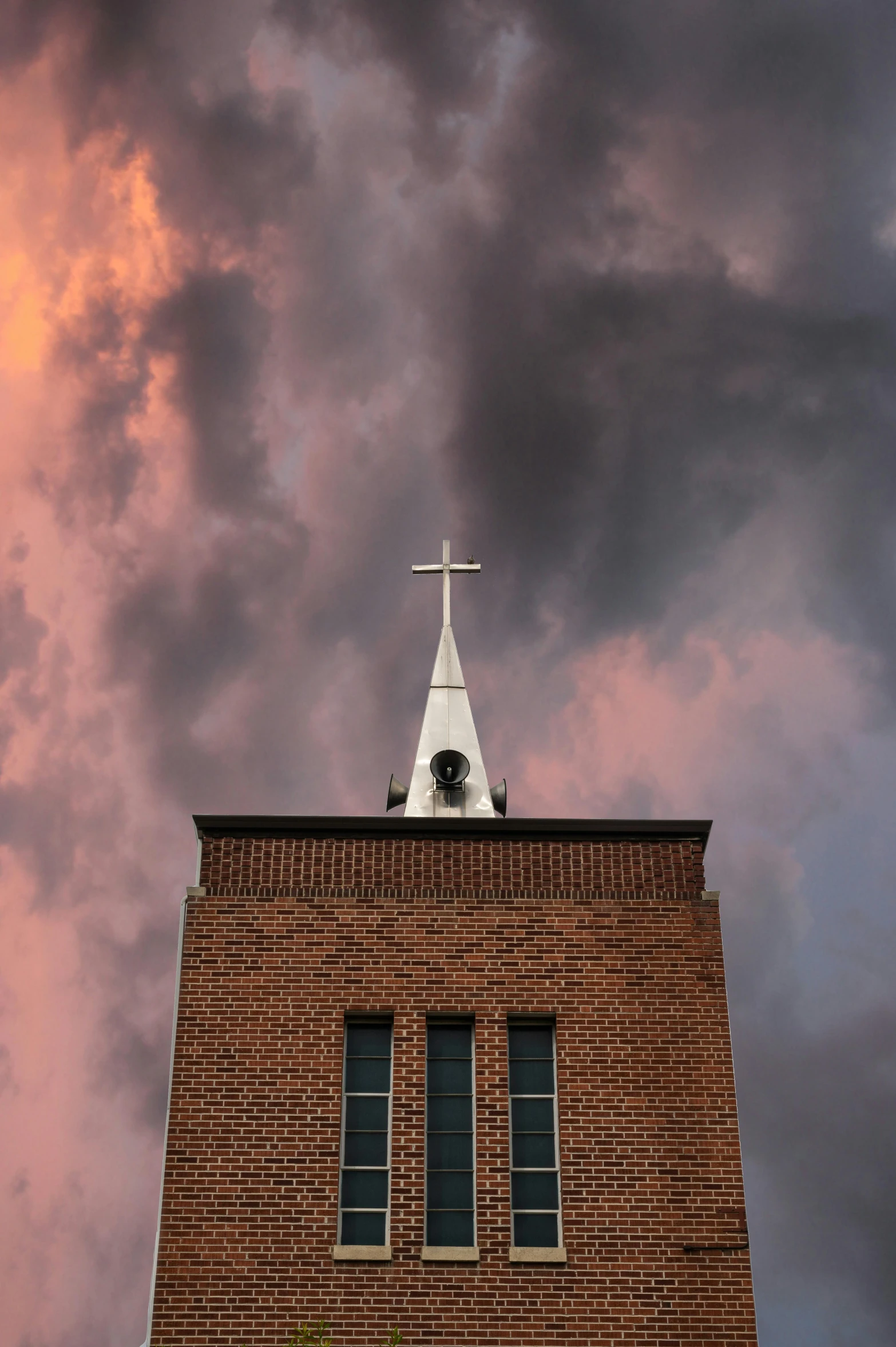 a church steeple with a cloudy sky in the background, by Jacob Burck, unsplash, brick building, burning clouds, ap news photograph, 15081959 21121991 01012000 4k