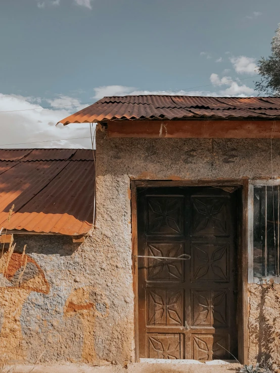 a motorcycle parked in front of a stone building, by Daniel Lieske, pexels contest winner, samburu, galvalume metal roofing, a screenshot of a rusty, inside house in village