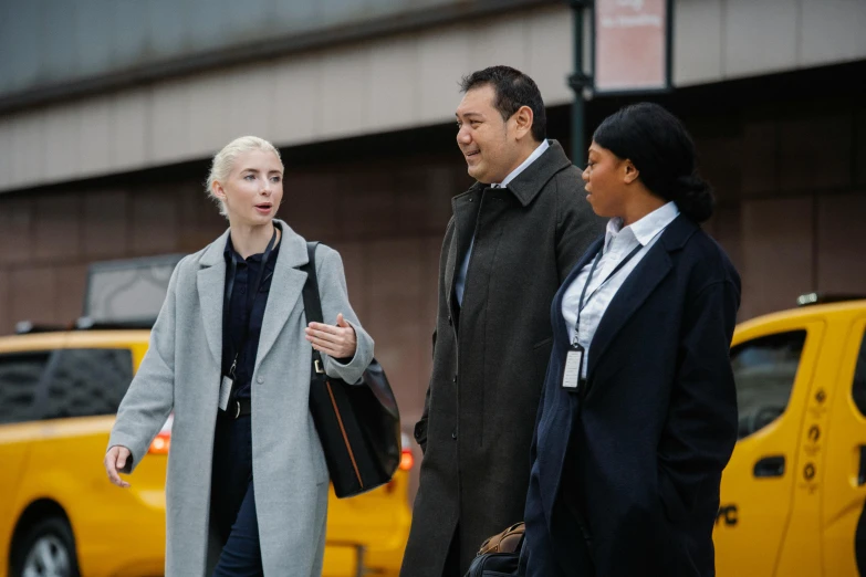 a group of people walking across a street, female investigator, diverse, promo image, in new york