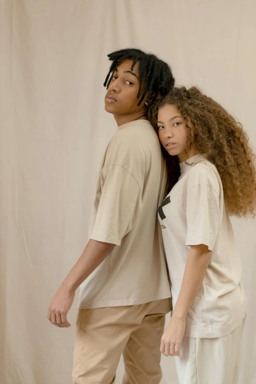 a man and a woman standing next to each other, trending on pexels, renaissance, wear's beige shirt, teenage boy, off - white collection, promotional image