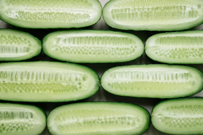 a close up of a bunch of sliced cucumbers, by Yasushi Sugiyama, pexels, photorealism, 🦩🪐🐞👩🏻🦳, rectangle, satisfying render, round-cropped
