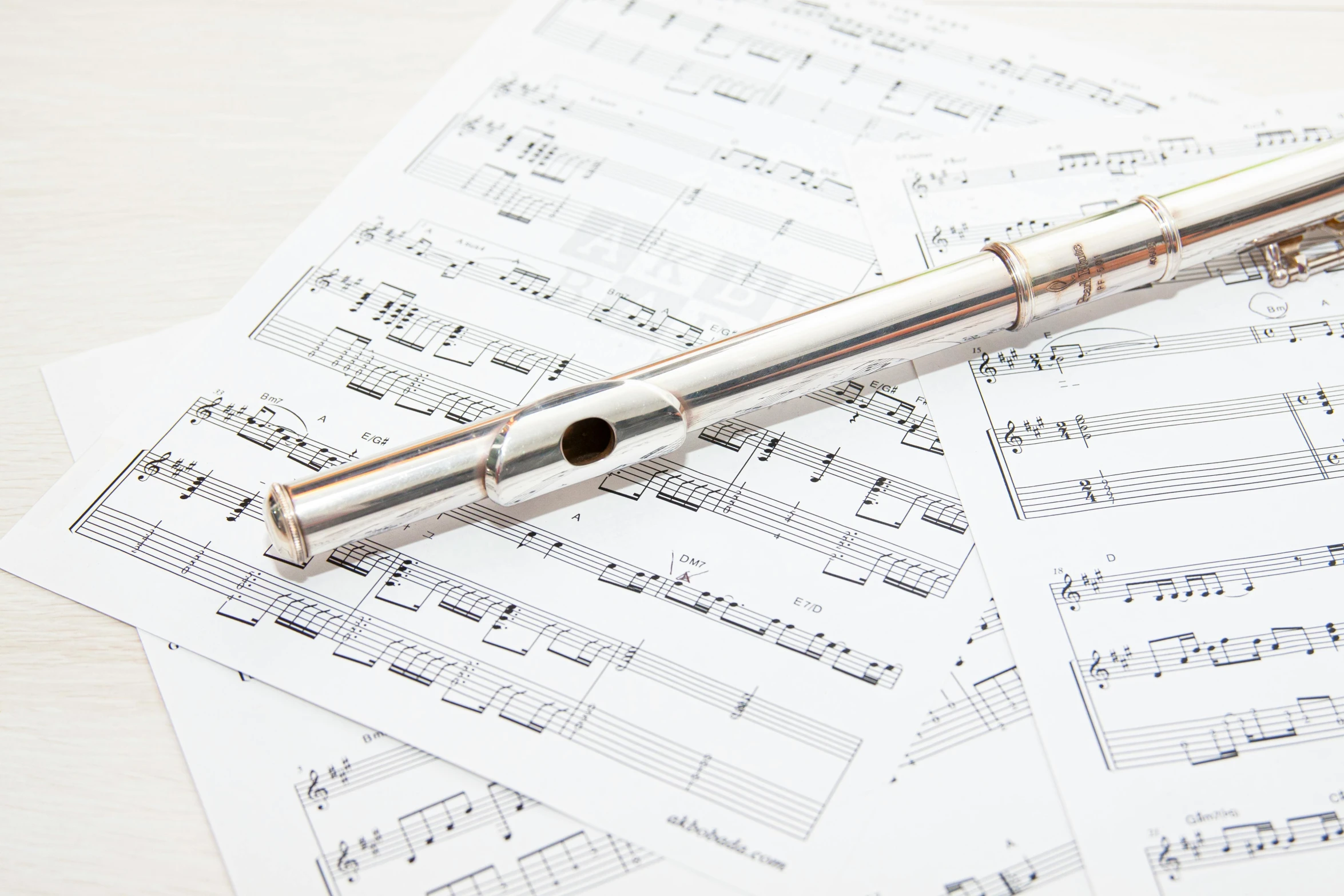 a flute sitting on top of sheet music, shutterstock, instagram post, shiny metal, vials, shiny crisp finish