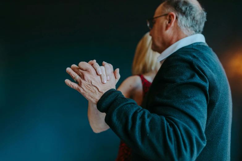 a man and a woman are dancing together, by Lee Loughridge, unsplash, holding paws, an oldman, shot from the side, normal hands