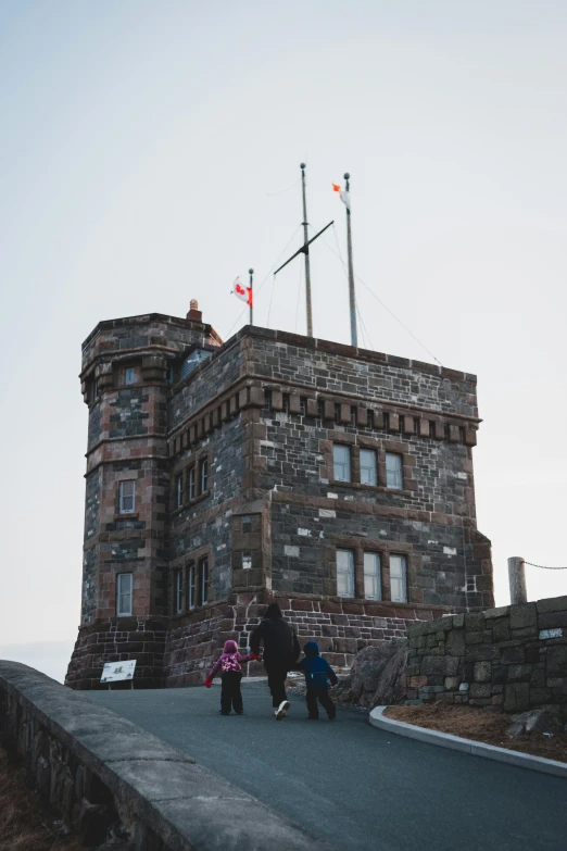 a couple of people that are standing in front of a building, edinburgh castle, lookout tower, wellington, 2019 trending photo