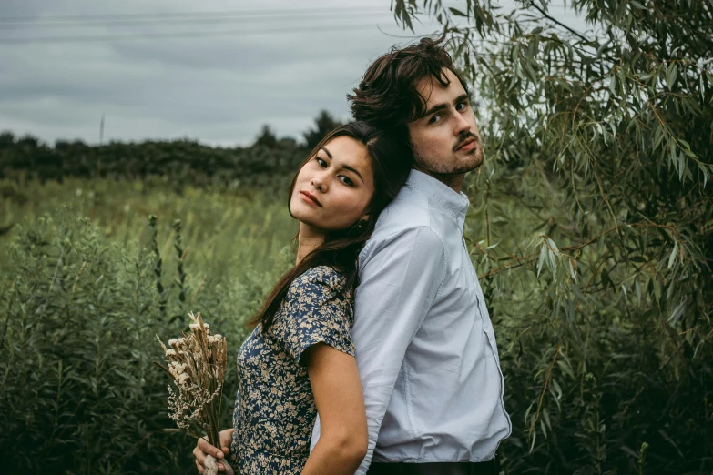 a man and woman standing next to each other in a field, a portrait, by Lucia Peka, pexels contest winner, sydney park, model pose, avatar image, half body photo