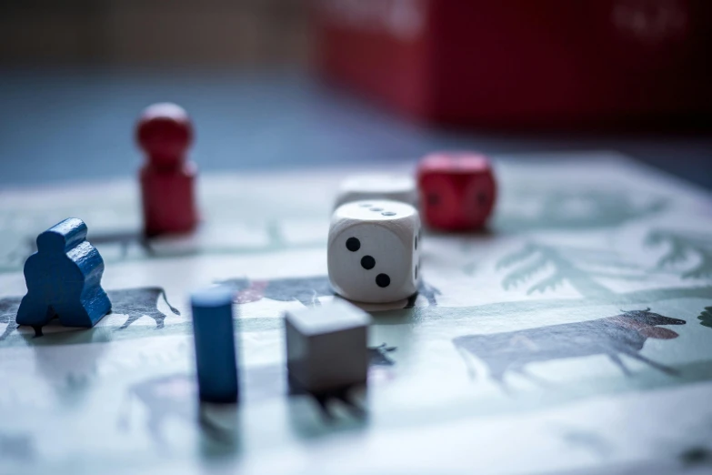 a couple of dice pieces sitting on top of a table, a picture, by Daniel Lieske, unsplash, square, hunting, families playing, grey