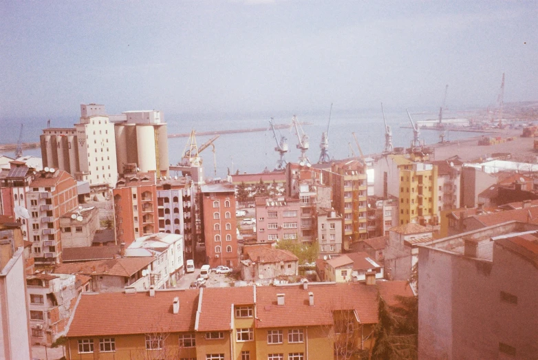 a view of a city from the top of a building, a colorized photo, ships in the harbor, georgic, medium format film photography, 2022 photograph
