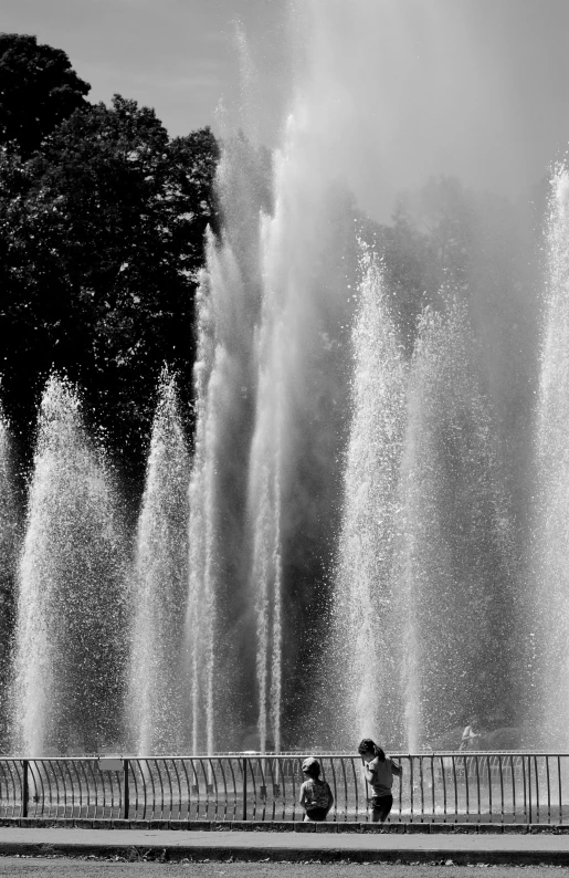 a black and white photo of a water fountain, a black and white photo, by Cherryl Fountain, paris 2010, lava waterfalls, colours, spines and towers