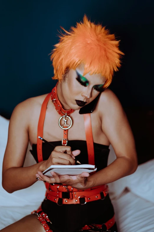 a woman sitting on top of a bed holding a cell phone, an album cover, inspired by Nan Goldin, trending on pexels, spiky orange hair, ru paul\'s drag race, writing on a clipboard, looking from side