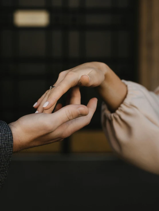 a man putting a ring on a woman's finger, trending on unsplash, renaissance, thumbnail, brown, connections, caring