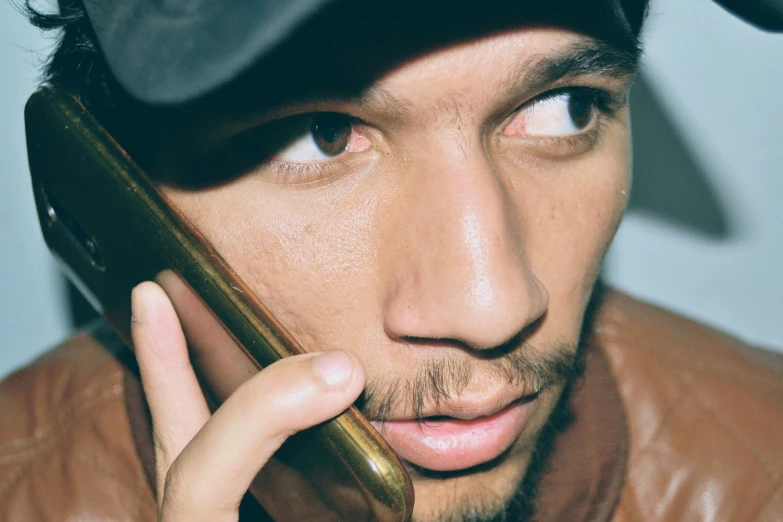 a close up of a person talking on a cell phone, an album cover, inspired by Byron Galvez, trending on pexels, photorealism, tom morello, tom hardy, light skin, telephone