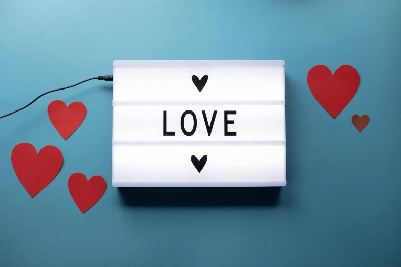 a light box with the word love written on it, by Julia Pishtar, mint, unbeatable quality, hearts, spotlight