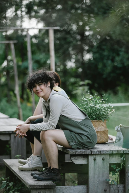 a woman sitting on top of a wooden bench, by Yosa Buson, trending on pexels, finn wolfhard, greenery, 2 people, asian female