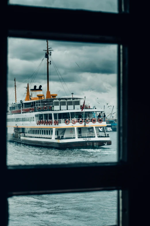 a large boat floating on top of a body of water, an album cover, by irakli nadar, pexels contest winner, inside large window of ship, istanbul, yellow, [ cinematic