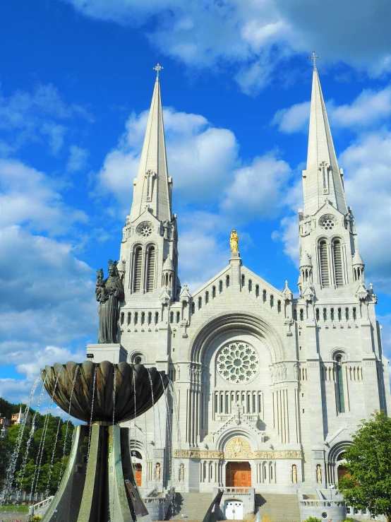 a large cathedral with a fountain in front of it, a statue, quebec, profile image, map, square