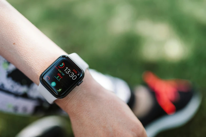 a person wearing a smart watch on their wrist, pexels, square, background image, sport, against the backdrop of trees