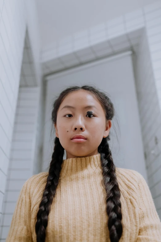 a woman with long hair standing in a bathroom, inspired by Kim Tschang Yeul, unsplash, hyperrealism, two pigtails hairstyle, in school hallway, wearing turtleneck, proud serious expression