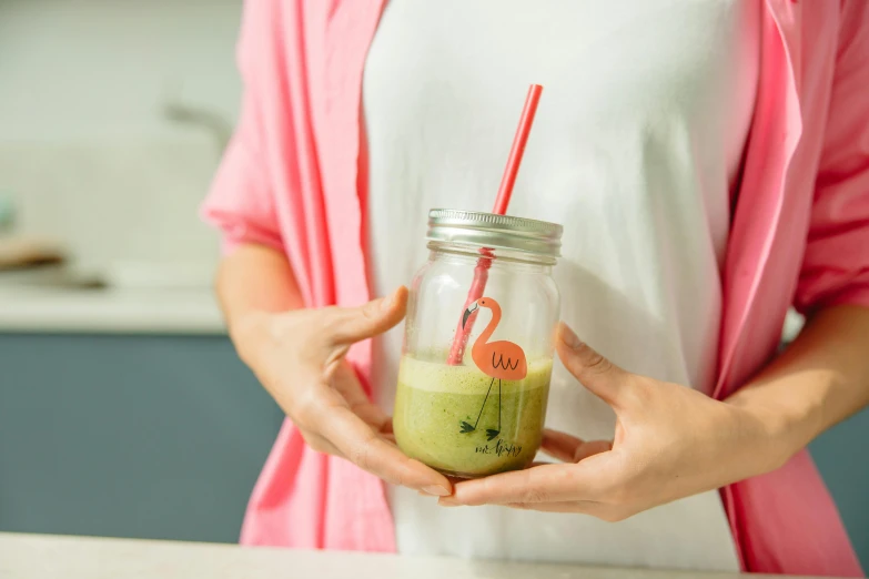 a woman holding a jar with a drink in it, green and pink colour palette, highly upvoted, medium close shot, recipe