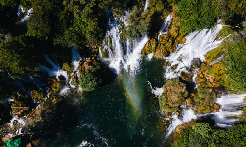 a waterfall in the middle of a lush green forest, pexels contest winner, hurufiyya, helicopter view, rainbow river waterfall, avatar image