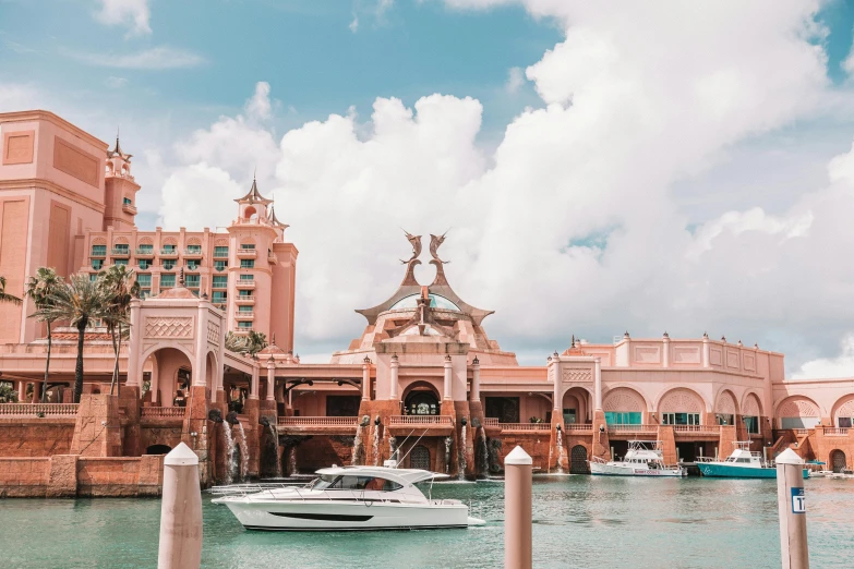 a boat in the water in front of a building, by Ryan Pancoast, pexels contest winner, pastel pink skin tone, near crystal temple in atlantis, casino, boat dock