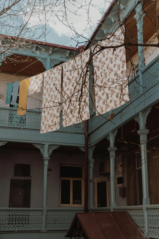 a couple of buildings that are next to each other, a colorized photo, inspired by Elsa Bleda, unsplash contest winner, art nouveau, greek fabric, outdoor art installation, in a dusty victorian home, tehran