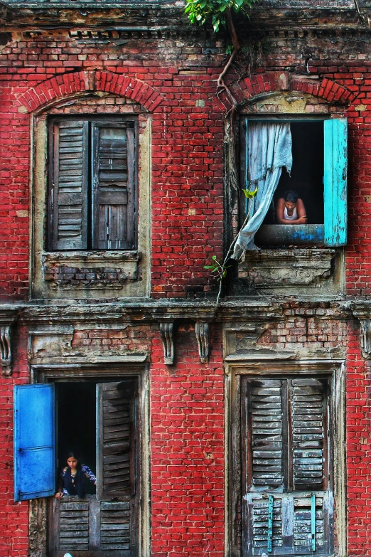 an old red brick building with blue shutters, pexels contest winner, bengal school of art, colored photo, staring, colors, photorealist