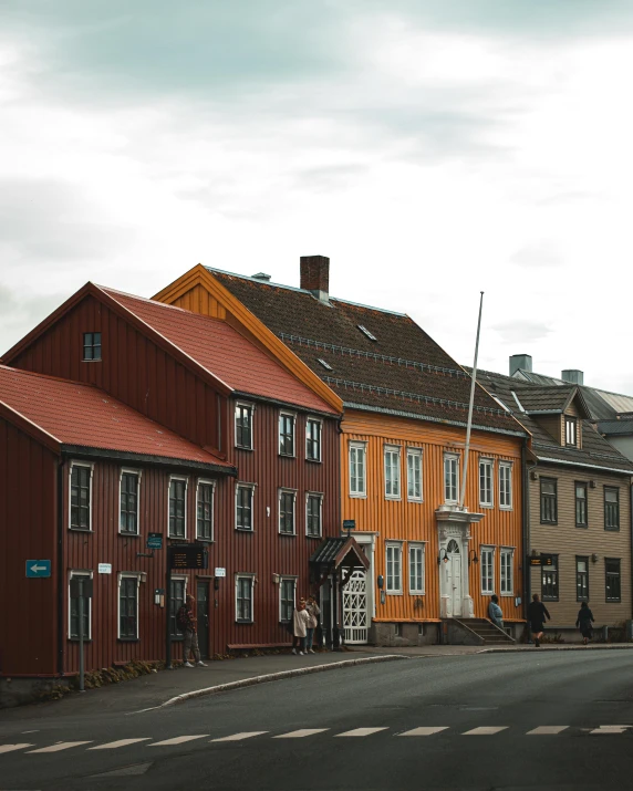 a group of buildings sitting on the side of a road, by Roar Kjernstad, pexels contest winner, renaissance, colorful and grayish palette, preserved historical, brown, exterior photo