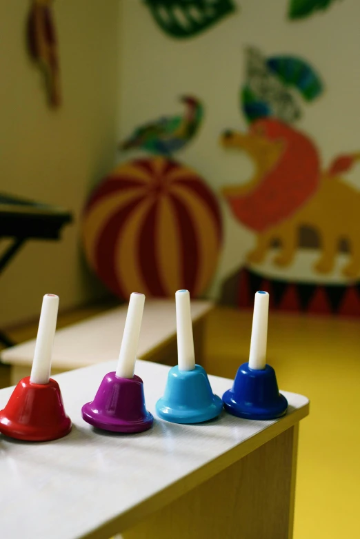 a row of toothbrushes sitting on top of a table, an album cover, activity play centre, bells, ap news photo, single horn