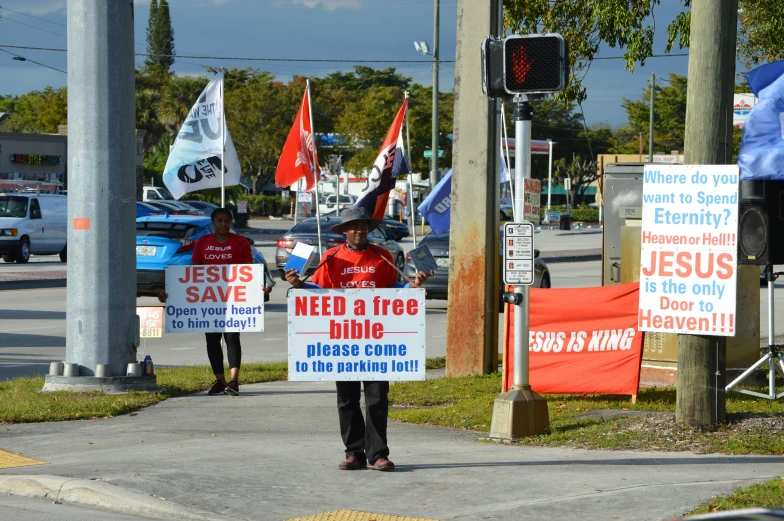 a group of people walking down a street holding signs, florida man, outside in parking lot, red banners, christian cline