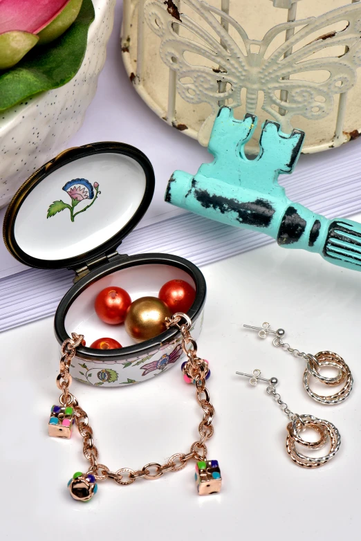 a bunch of jewelry sitting on top of a table, a still life, inspired by Eden Box, cloisonnism, open vault, medium close shot, emma bridgewater and paperchase, detailed product image