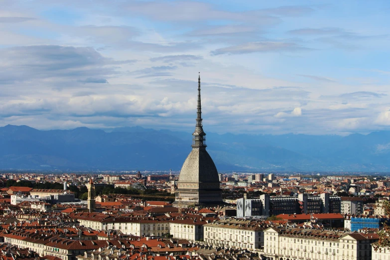 a view of a city with mountains in the background, by Giorgio De Vincenzi, pexels contest winner, renaissance, lead - covered spire, overlooking, brown, broad