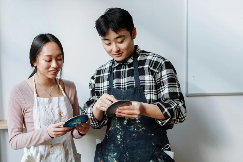 a man and a woman standing next to each other, inspired by Yukimasa Ida, pexels contest winner, cloisonnism, holding a paintbrush in his hand, jordan grimmer and natasha tan, plating, ouchh and and innate studio