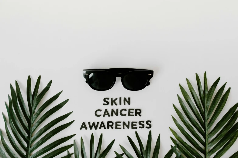 a pair of sunglasses sitting on top of palm leaves, trending on pexels, aestheticism, minimal black skull warpaint, poster template on canva, skincare, the cure for cancer