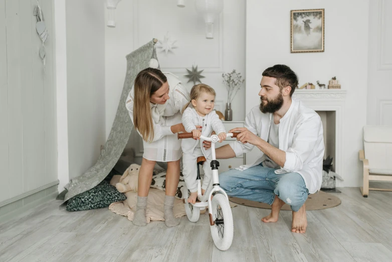 a family playing with a bicycle in the living room, inspired by The Family Circus, pexels contest winner, full white beard, havrylo pustoviyt, decoration, profile pic