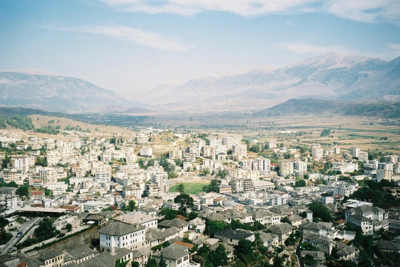 a view of a city with mountains in the background, an album cover, unsplash, hurufiyya, 1990s photograph, villages, mount olympus, 2000s photo