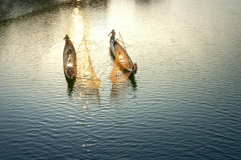 a couple of boats that are in the water, by Jan Tengnagel, pexels contest winner, hurufiyya, myanmar, soft warm light, fan favorite, a high angle shot