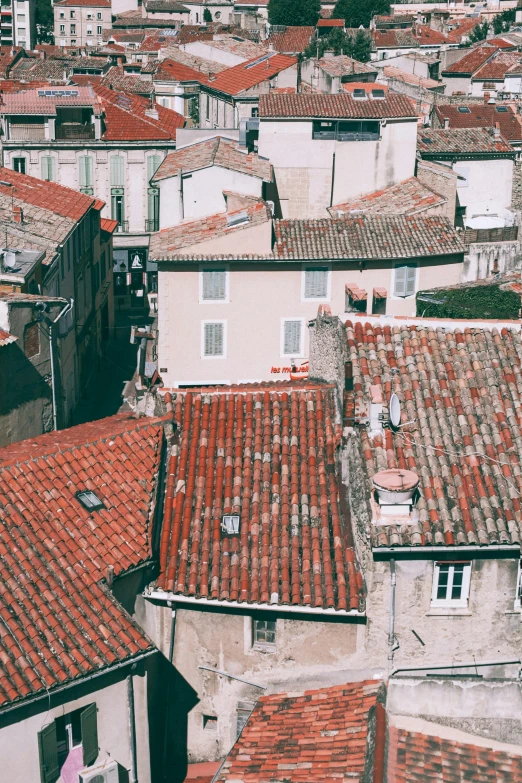 a view of a city from the top of a building, a picture, pexels contest winner, renaissance, french village exterior, 1990's photo, tiled roofs, red building