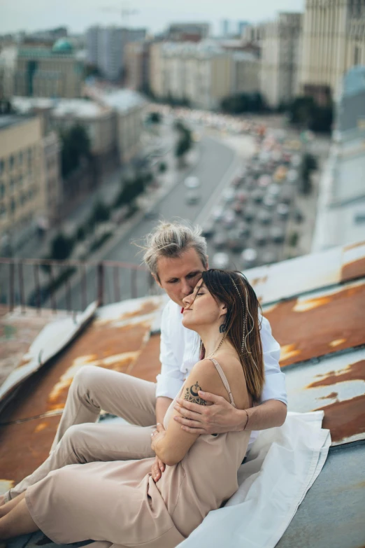 a man and a woman sitting on top of a building, pexels contest winner, romanticism, russian girlfriend, soft texture, laying down, headshot