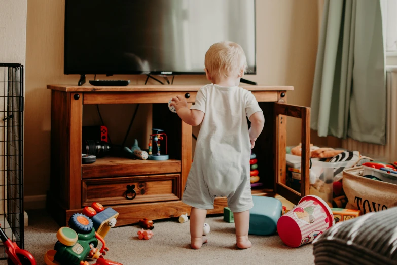 a toddler standing in front of a flat screen tv, pexels contest winner, happening, toy room, crawling on the ground, conor walton, trustworthy