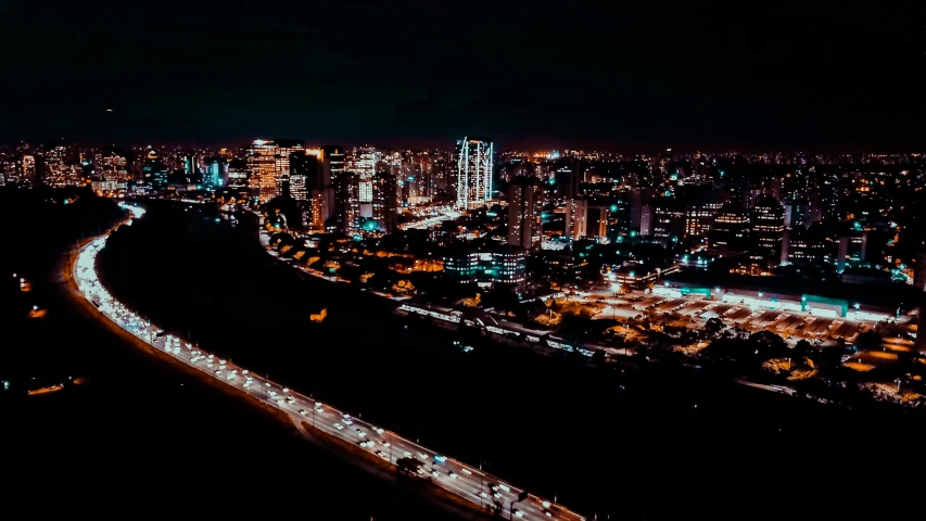 an aerial view of a city at night, an album cover, by Alejandro Obregón, pexels contest winner, hurufiyya, long view, manila, desktop background, high light on the left