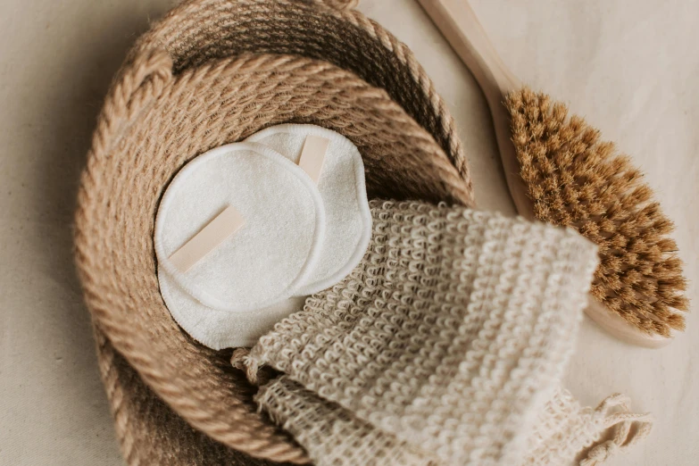 a basket filled with cleaning supplies on top of a table, by Emma Andijewska, trending on pexels, skin texture natural, bandage, beige, a close-up