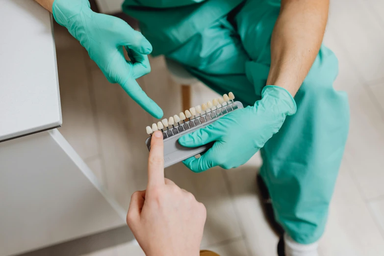 a close up of a person holding a toothbrush, surgical implements, profile image, uniform teeth, brown scales