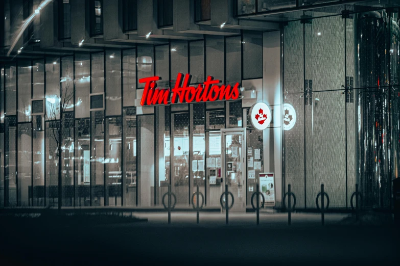 a building that has a sign in front of it, an album cover, by Thomas Häfner, trending on unsplash, mcdonalds interior background, tom hiddleston, night time footage, 🦩🪐🐞👩🏻🦳