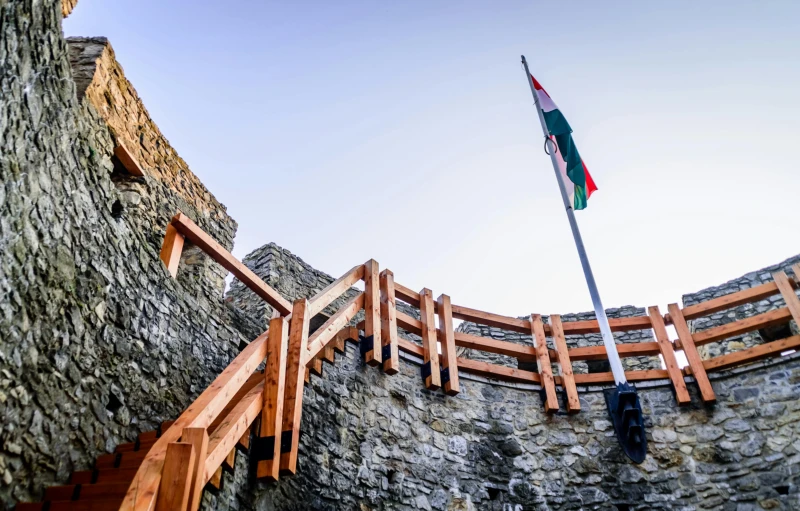 a building with a flag on top of it, pexels contest winner, renaissance, castle wall, hungarian, dug stanat, promo image