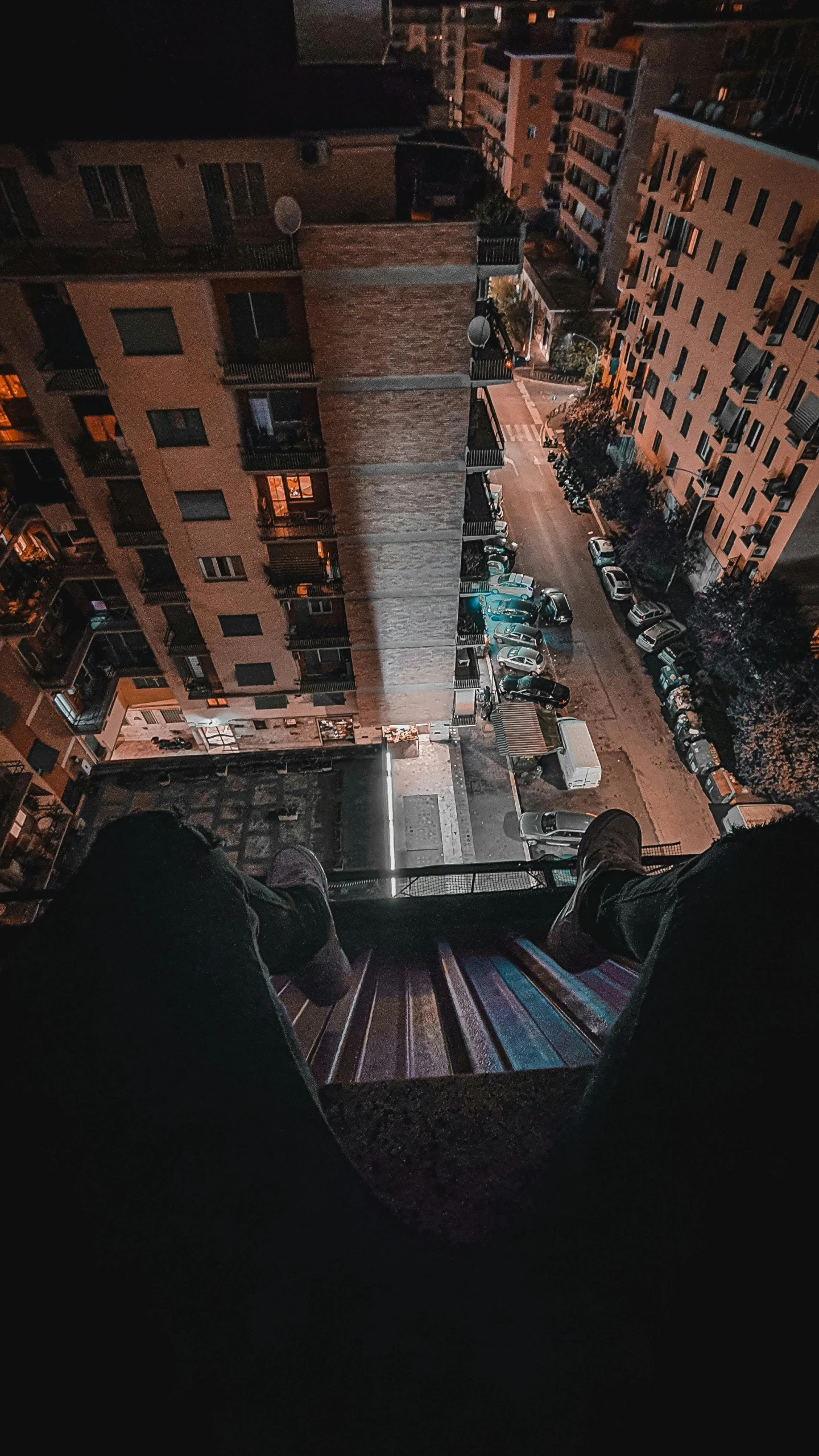 a view of a city at night from the top of a building, an album cover, unsplash contest winner, doing a kickflip over stairs, sitting in a crane, instagram story, spooky photo